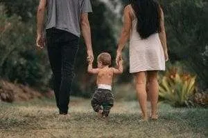 couple walking with baby